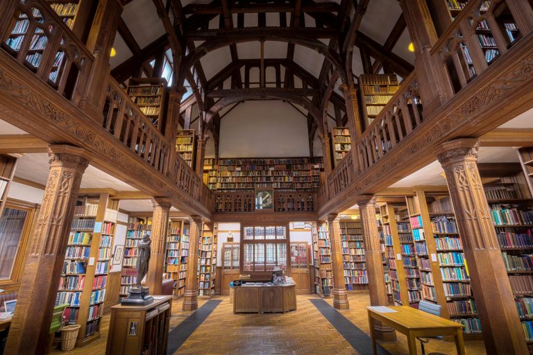 Beautiful interior view of Gladstone's Library, showcasing its wooden architecture and extensive book collection.
